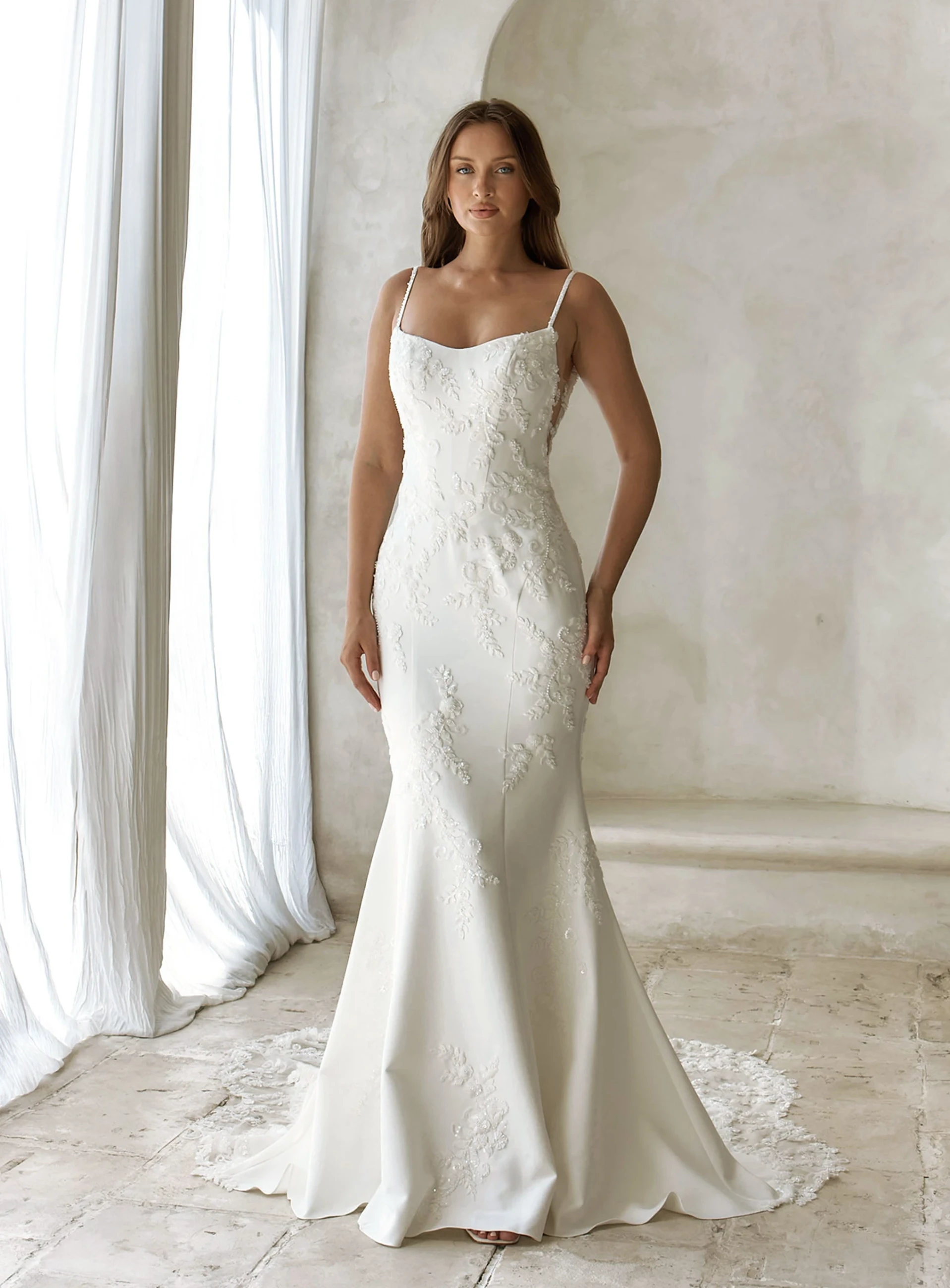 Model wearing a Justin Alexander dress